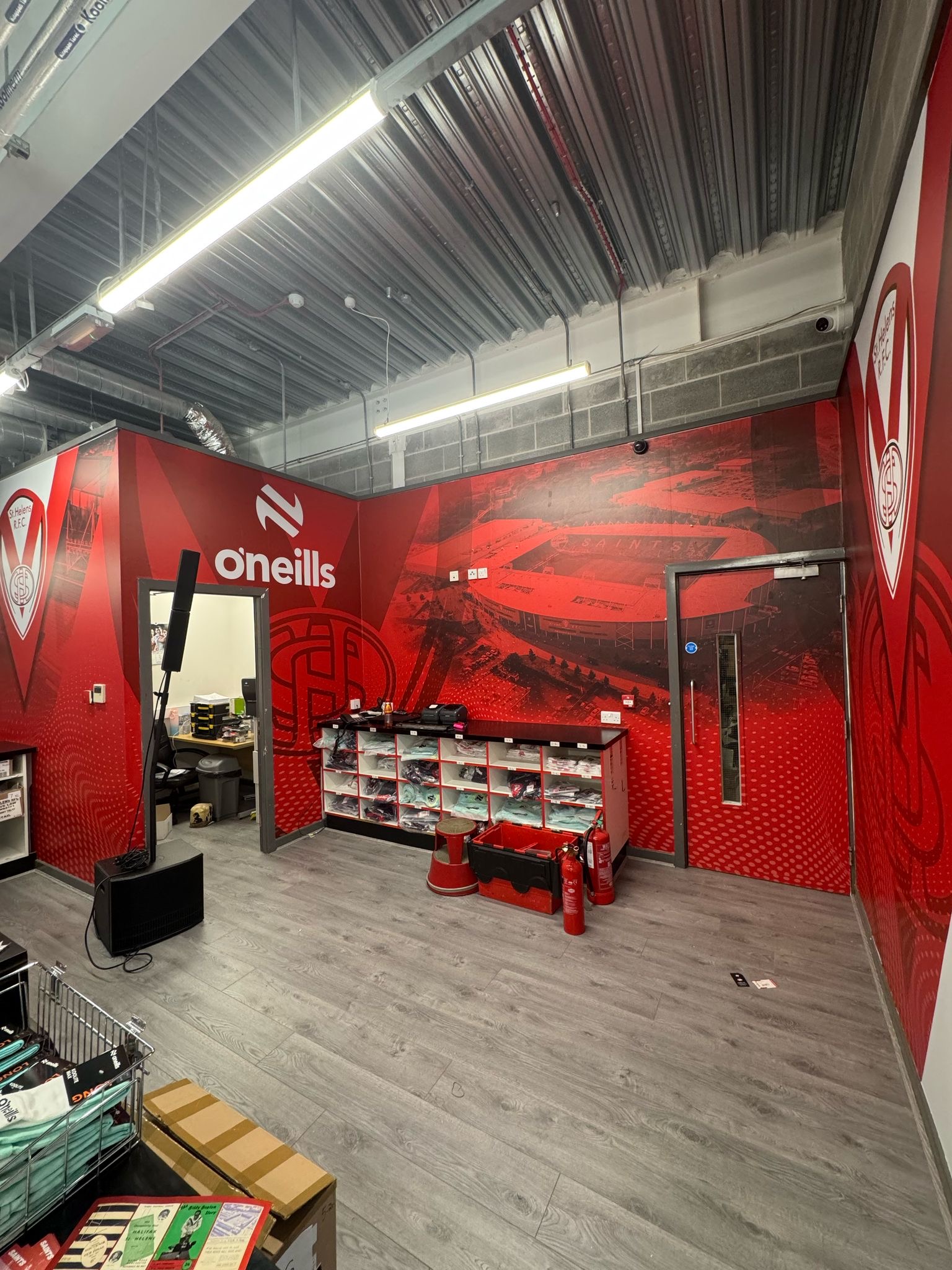 Digitally printed high-tack vinyl wall graphics installed in Saints Super Store by Vinyline