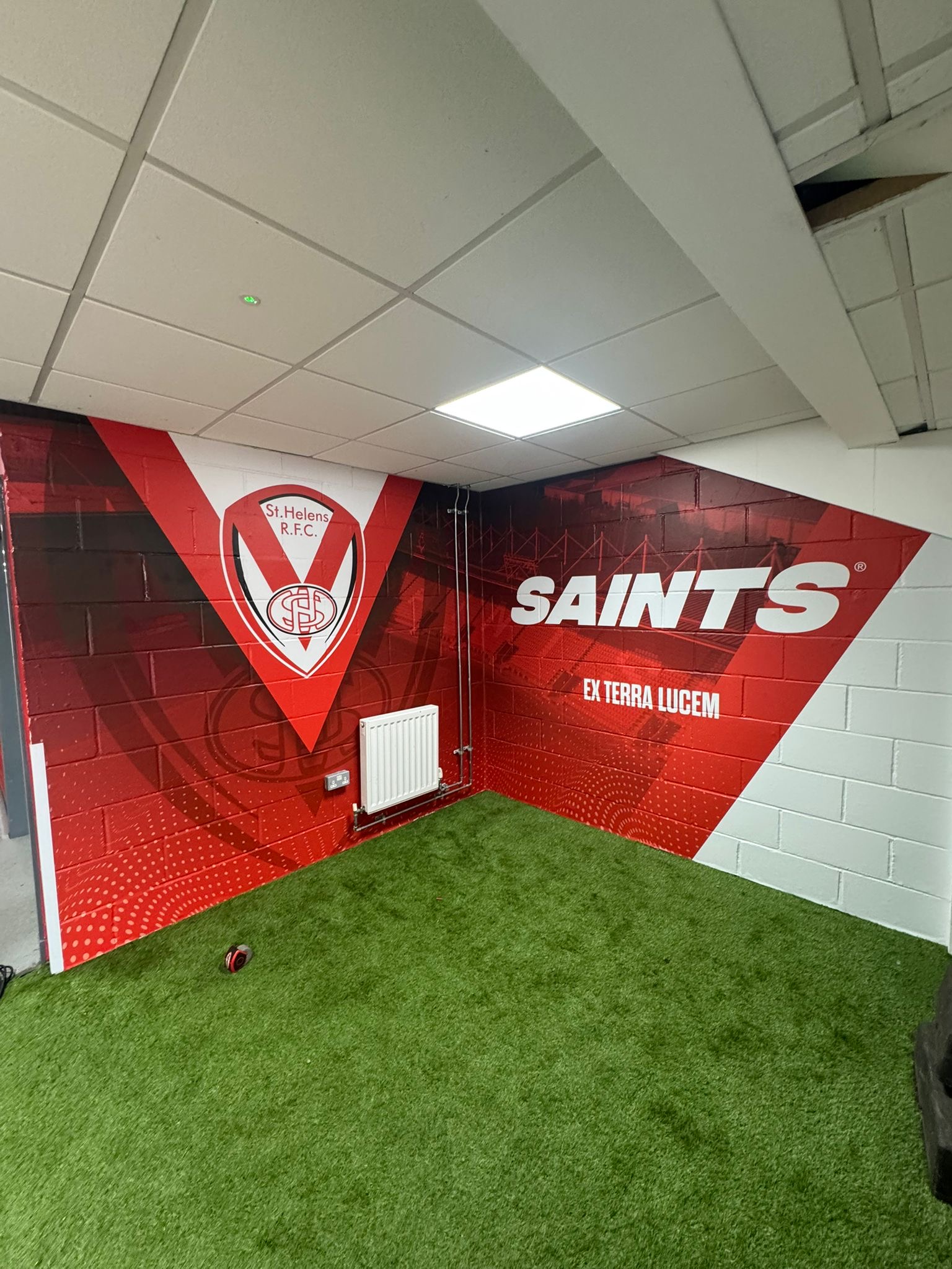 Digitally printed high-tack vinyl wall graphics installed in Saints Super Store by Vinyline