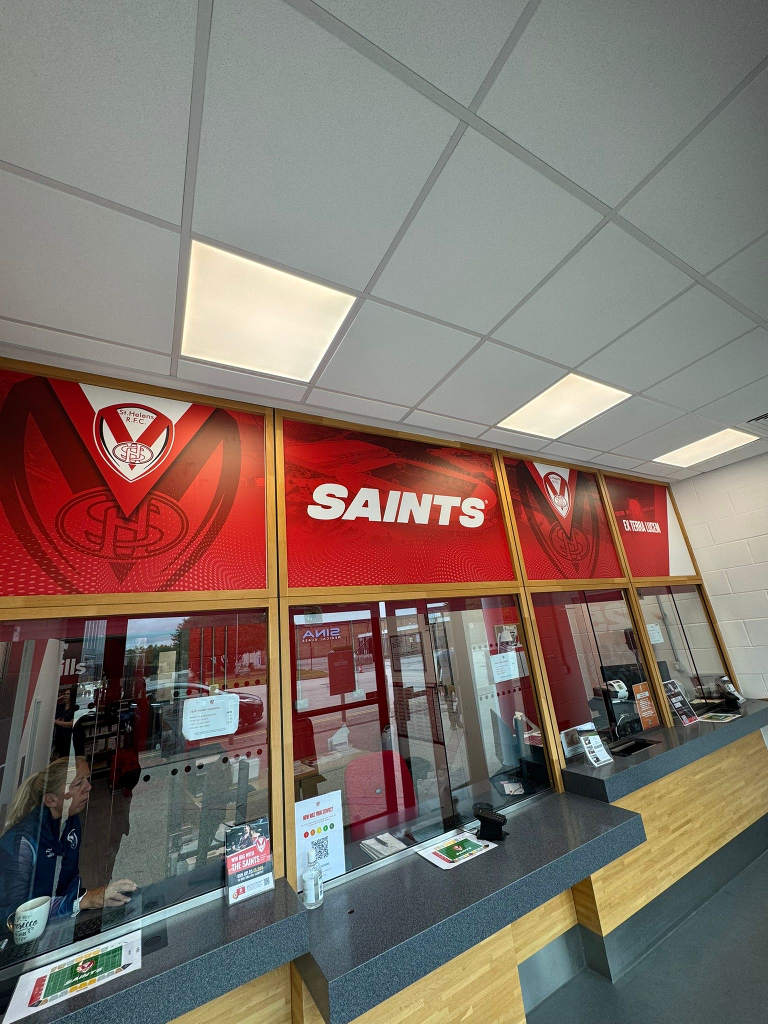 Digitally printed high-tack vinyl wall graphics installed in Saints Super Store by Vinyline