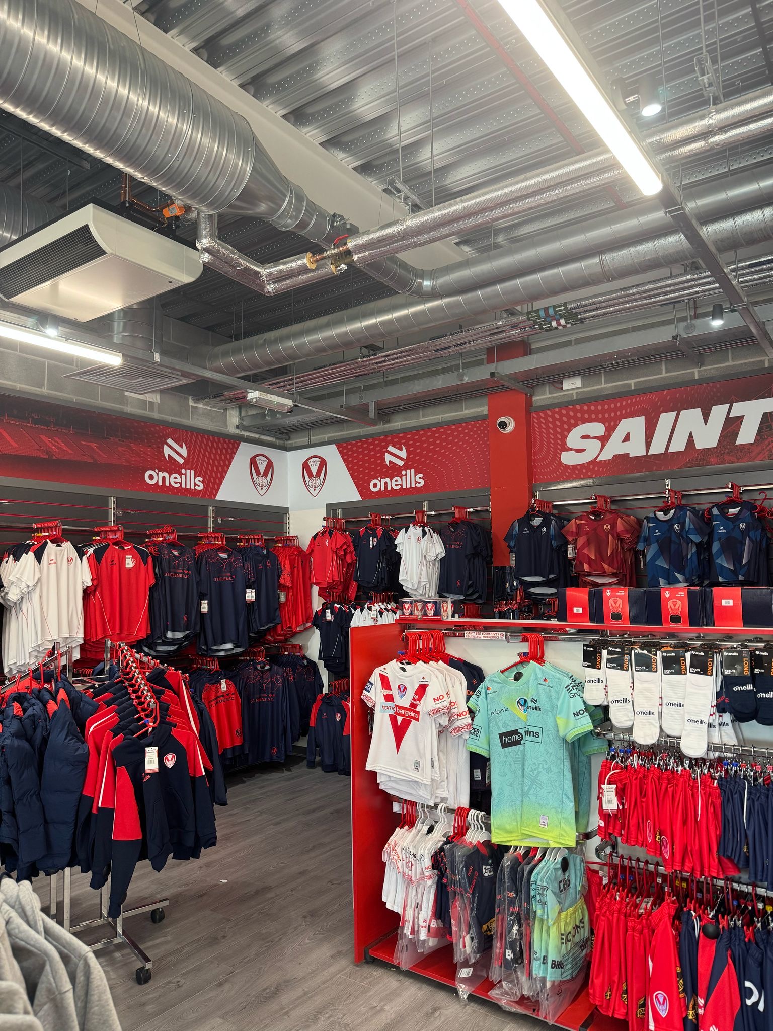 Digitally printed high-tack vinyl wall graphics installed in Saints Super Store by Vinyline