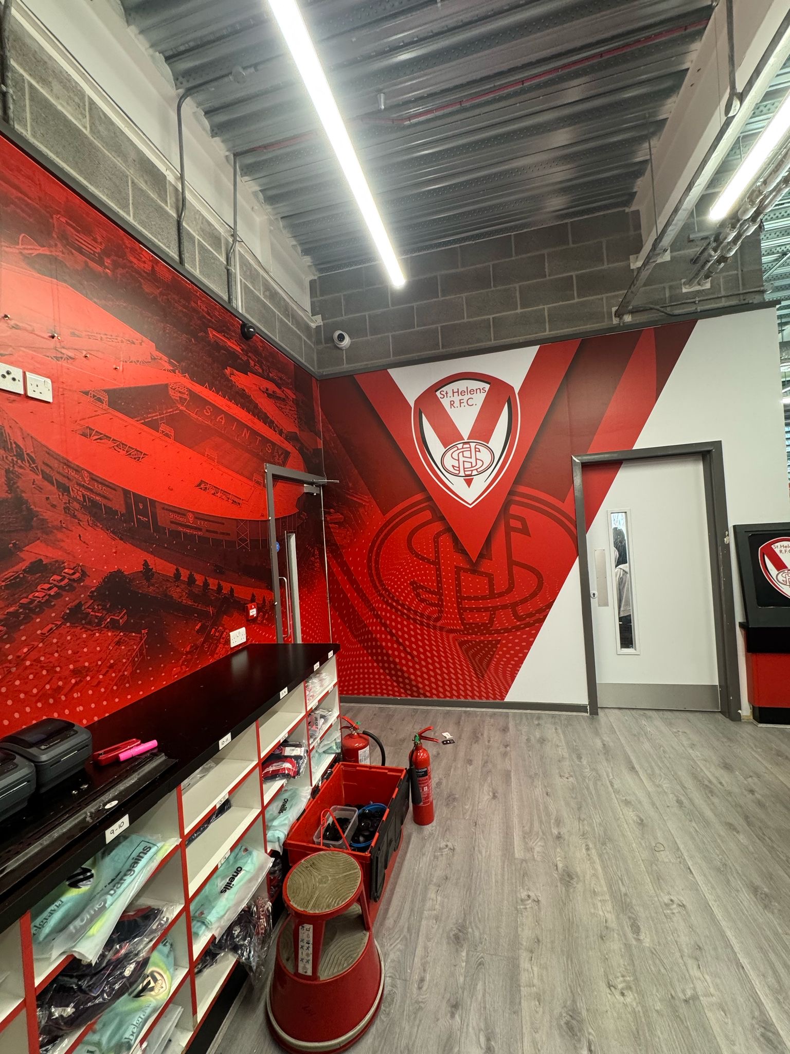 Digitally printed high-tack vinyl wall graphics installed in Saints Super Store by Vinyline