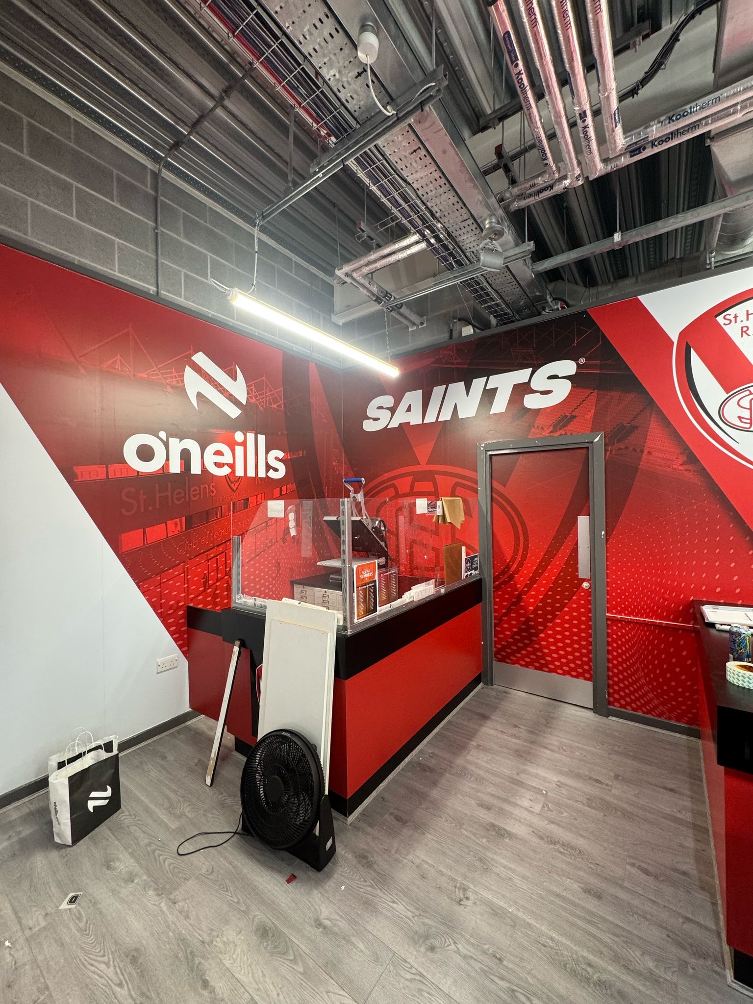 Digitally printed high-tack vinyl wall graphics installed in Saints Super Store by Vinyline