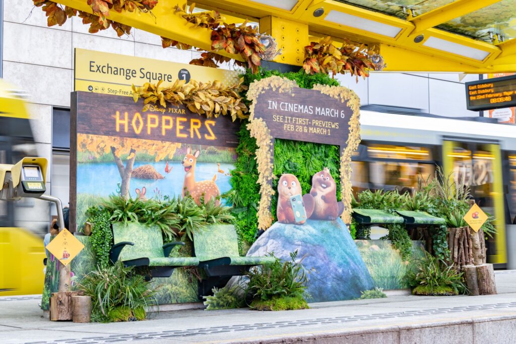 Outdoor advertising graphics takeover at Exchange Square tram stop Manchester