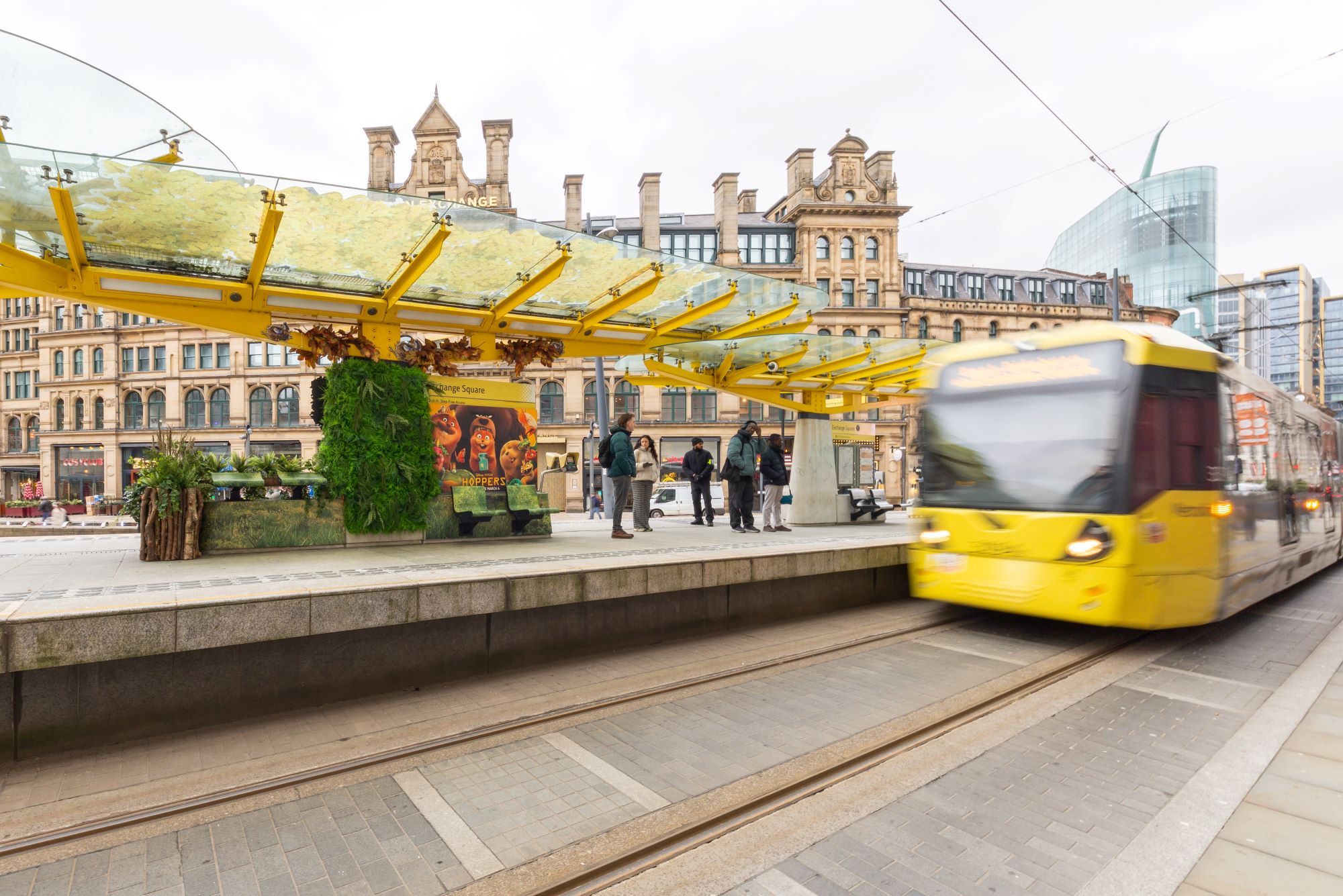 Detailed advertising graphics installation using textured wall vinyl in public transport settin