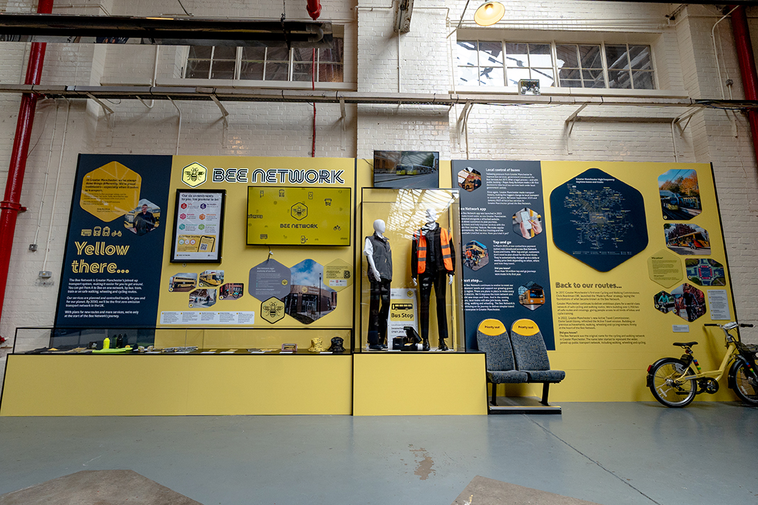 Bee Network exhibition display at Manchester Transport Museum featuring illuminated graphics, interactive displays, acrylic showcases and transport heritage exhibits.