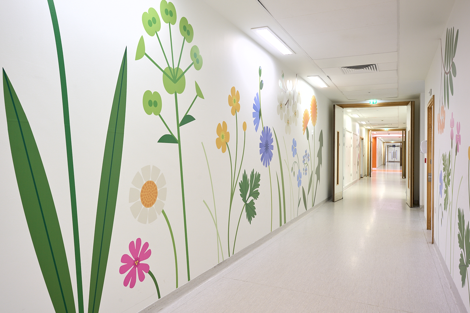 Individually cut vinyl flowers installed at Alder Hey